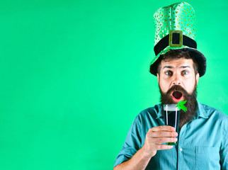 St Patrick's Day. Surprised man holds glass of beer on St.Patrick's day. Saint Patrick's Day...