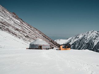 Shymbulak Ski Resort in Almaty mountains with traditional yurt. now-capped Tian Shan in Almaty city, Kazakhstan, Central Asia.