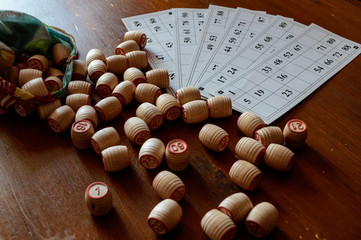 Cards and kegs for Russian lotto (bingo game) on a wooden table.