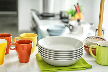 Shelving with different clean dishes in kitchen