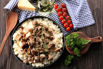 Composition with delicious risotto on wooden background