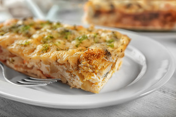 Plate with tasty broccoli casserole on table. Fresh from oven