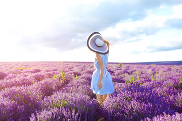 Young woman in lavender field on summer day