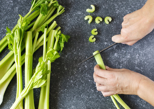 Woman cutting a fresh celery