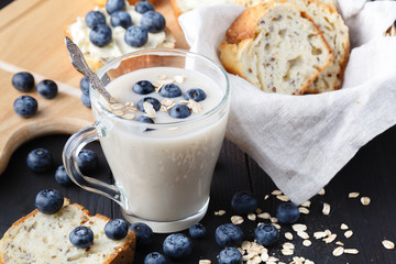 Healthy breakfast: overnight oats with fresh blueberries in a glass jar
