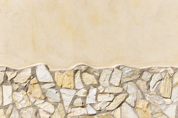 cement wall background decorated with stones