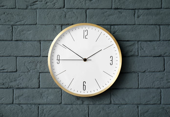 Modern clock on brick wall. Time concept