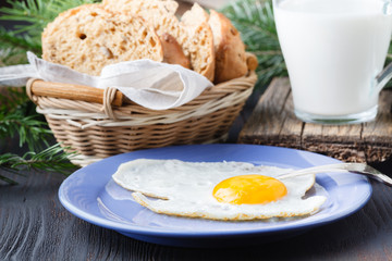Rural breakfast with eggs and spices on a wooden background