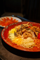 Yusheng or Prosperity Toss is a Cantonese-style raw fish salad. It is considered a symbol of abundance for Chinese New Year. Diners will toss the ingredients while saying 