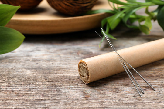 Moxa Stick With Needles For Acupuncture On Wooden Table