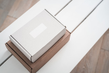 Craft boxes on white table from above. Product packaging, branding mockup, delivery service.