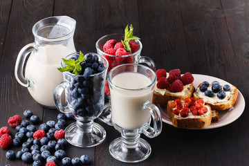 Healthy breakfast overnight oats with fresh berries in a glass jar