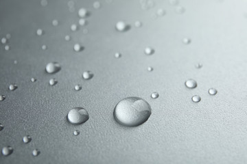 Fototapeta na wymiar Many clean water drops on grey background