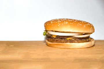 Hamburger on the orange wooden desk