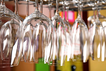 Clean glasses hanging over counter in bar