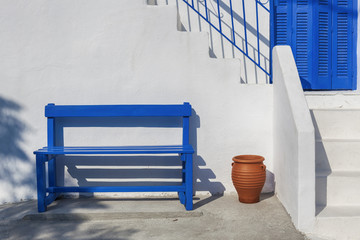 Traditional White Houses with Blue Door and bench in Greece