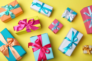 Flat lay composition with beautiful gift boxes on color background