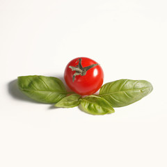 Cherry tomato with basil leafs Isolated on white background