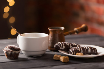hot black coffee with cookies and beans in cafe