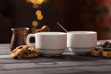hot black coffee with cookies and beans in cafe
