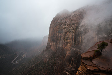 Foggy cliffs above canyon and road in Zion National Park, Utah