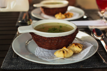 Delicious Chicken  Soup in a Beautiful White Bowl, Decorated Basket With Tasty Bun