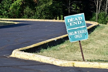 dead end road with deliveries only sign