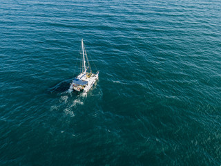 sailing boat catamaran in open sea summer cruise travel concept