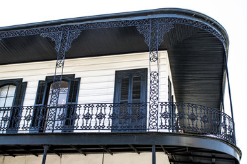 Beautiful Black Wrought Iron Balcony on a Classic White Home with Black Shutters and Detailing in...