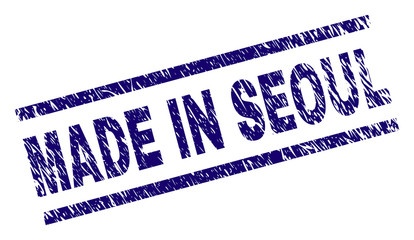 MADE IN SEOUL stamp seal watermark with grunge style. Blue vector rubber print of MADE IN SEOUL text with grunge texture. Text label is placed between parallel lines.