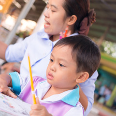 Obraz premium Mother is teaching her son