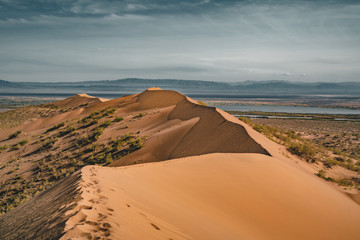 Sand dunes under blue sky. Sahara Desert, Previously, village houses transferred due to sands...