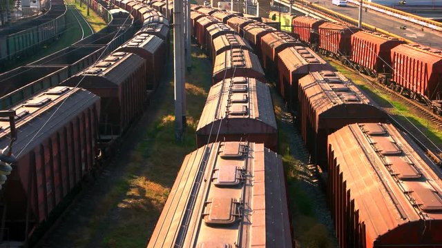 Long railway freight trains with lots of wagons. Top aerial view. Logistic and transportation concept.