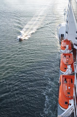 A small coastal boat used by port services on the high seas off the coast of Scotland.