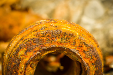 Very rusty metal on a gray cracked rock