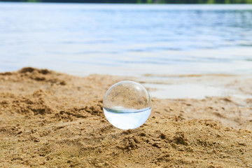  Glass ball at the sand beach
