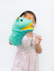 Little Asian child girl hand wear and playing Rhinoceros puppets on white background. Educations...