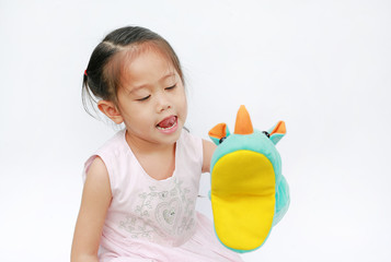 Adorable little Asian child girl hand wear and playing Rhinoceros puppets on white background.