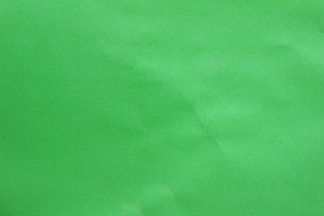 green paper texture background, empty space for text.