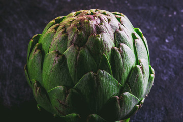 Obraz premium ARTICHOKE. Close up of artichoke, top view, dark background. Macro