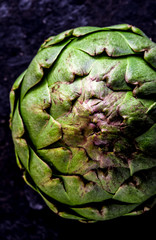 Obraz premium ARTICHOKE. Close up of artichoke, top view, dark background. Macro