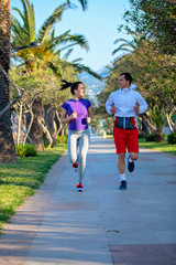 Obraz premium Urban sports, healthy young couple jogging in the city at sunny morning
