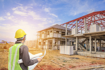 Professional engineer architect worker with protective helmet and blueprints paper at house...