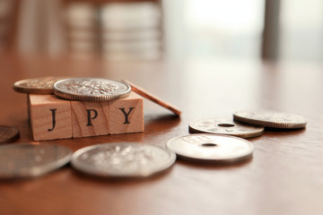 JPY (Japanese Yen) Text Block on Wooden Table