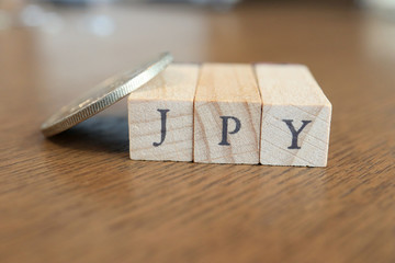 JPY (Japanese Yen) Text Block on Wooden Table