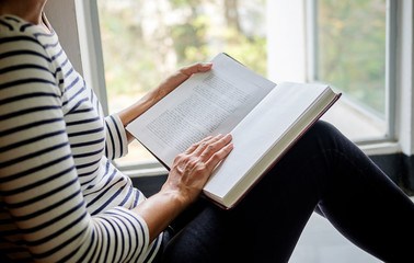 Woman is reading and praying over bible
