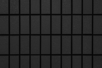 Black brick wall pattern and seamless background