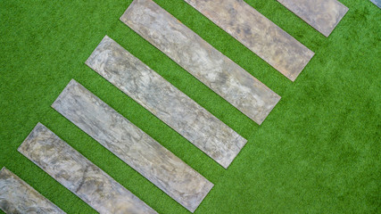 Aerial top view concrete pathway and artificial grass.