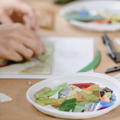 Obraz na płótnie Canvas Closeup photo of creative woman making bright mosaic