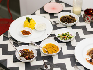 Traditional Sri Lankan curry with saffron rice, lentils, spices and greens, served in a white dish